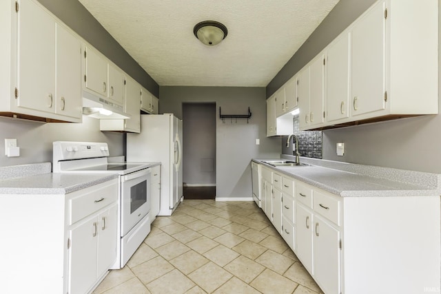 kitchen with white appliances, a sink, under cabinet range hood, light countertops, and baseboards