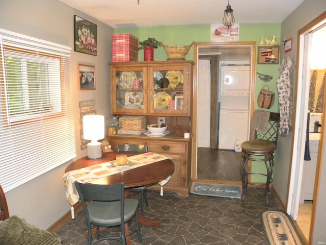 5161 Orange Grove Rd, Gosport, IN 47433 - dining space with estacked washer and dryer, healthy amount of natural light, dark stone finish floors, and baseboards