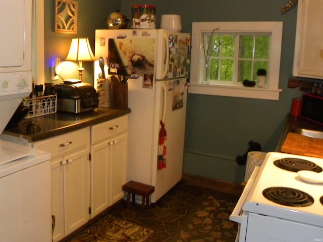 5161 Orange Grove Rd, Gosport, IN 47433 - kitchen featuring estacked washer and dryer, white appliances, white cabinets, and dark countertops