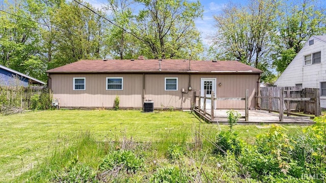 rear view of property with cooling unit