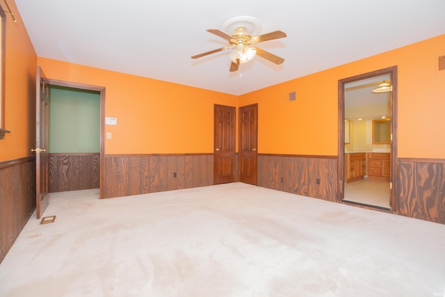 927 S Lombard Ave, Evansville, IN 47714 - carpeted spare room featuring a wainscoted wall, ceiling fan, and wooden walls