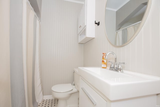 927 S Lombard Ave, Evansville, IN 47714 - bathroom with toilet, vanity, and ornamental molding