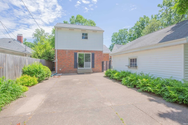 927 S Lombard Ave, Evansville, IN 47714 - back of property with brick siding, fence, and a patio