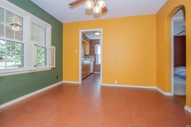 927 S Lombard Ave, Evansville, IN 47714 - unfurnished room featuring a ceiling fan, baseboards, plenty of natural light, and arched walkways