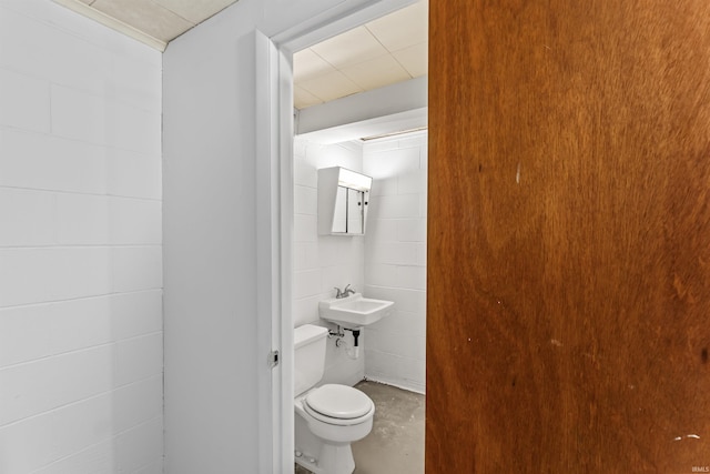 625 Cumberland Ave, West Lafayette, IN 47906 - half bath featuring concrete floors, toilet, a sink, and concrete block wall