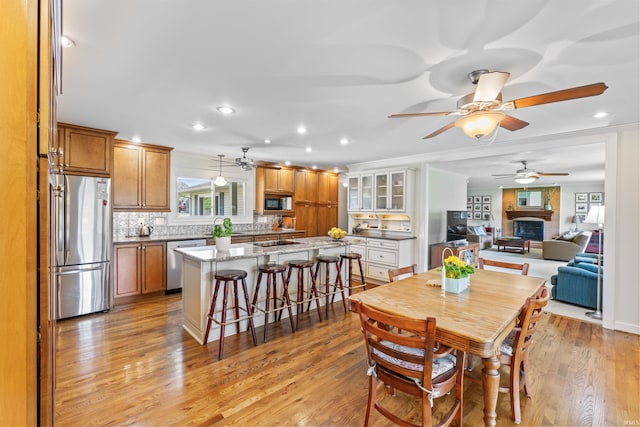 625 Cumberland Ave, West Lafayette, IN 47906 - dining area with a ceiling fan, a large fireplace, light wood-style floors, and recessed lighting