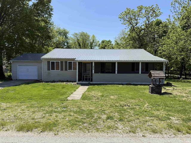 view of front of home featuring a garage, a front yard, asphalt driveway, a sunroom, and metal roof