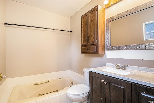 bathroom featuring toilet, a jetted tub, and vanity