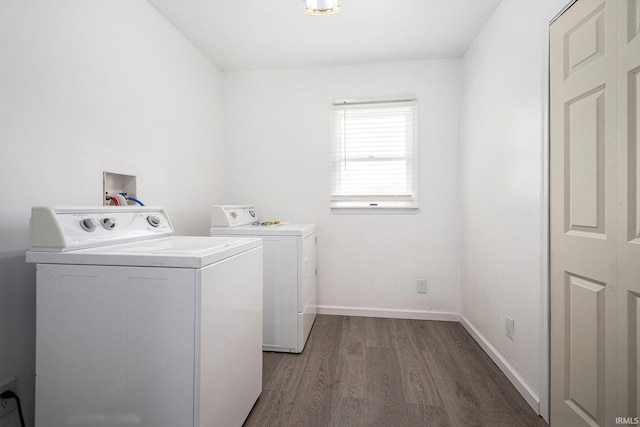 laundry room featuring independent washer and dryer, wood finished floors, and baseboards