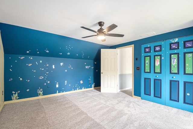 unfurnished bedroom featuring carpet flooring, a closet, ceiling fan, and baseboards