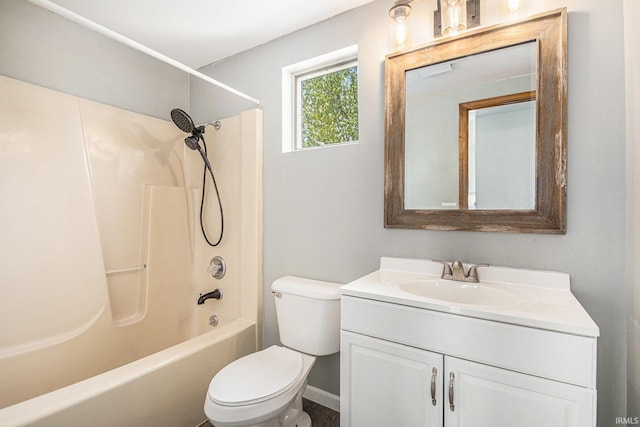 bathroom with toilet, vanity, baseboards, and shower / washtub combination