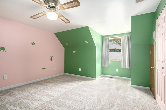 additional living space with baseboards, a ceiling fan, light carpet, and lofted ceiling