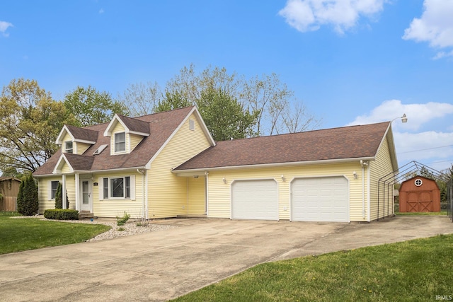 new england style home featuring a garage, driveway, a front yard, and roof with shingles