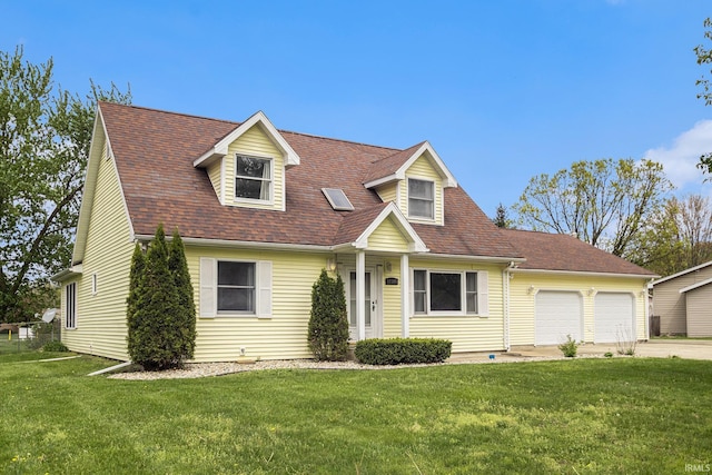 new england style home featuring a garage, a front yard, and concrete driveway