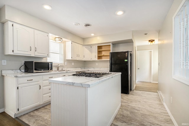 kitchen with stainless steel appliances, a sink, baseboards, white cabinets, and open shelves