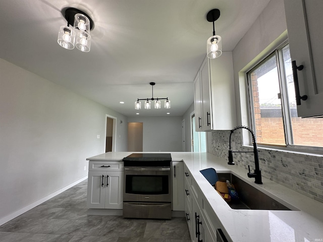100 Lincoln St, Plainfield, IN 46168 - kitchen featuring stainless steel electric range oven, a sink, a peninsula, backsplash, and light stone countertops