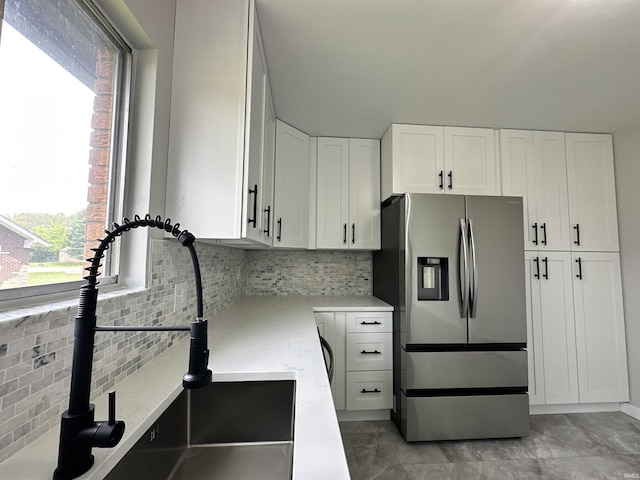 100 Lincoln St, Plainfield, IN 46168 - kitchen with stainless steel fridge, a sink, light stone countertops, white cabinets, and decorative backsplash