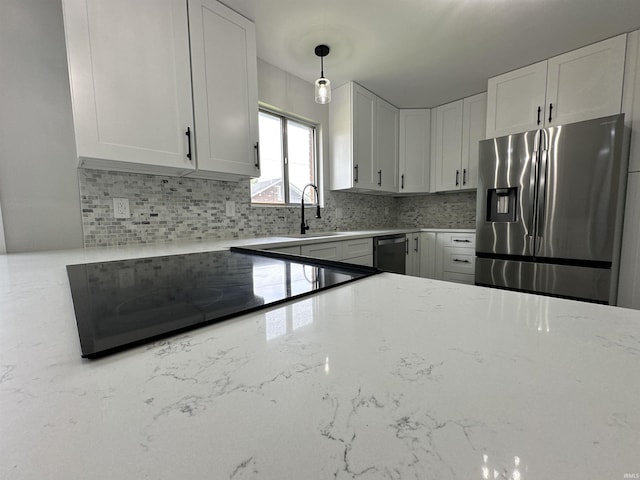 100 Lincoln St, Plainfield, IN 46168 - kitchen featuring stainless steel fridge with ice dispenser, a sink, cooktop, and decorative backsplash