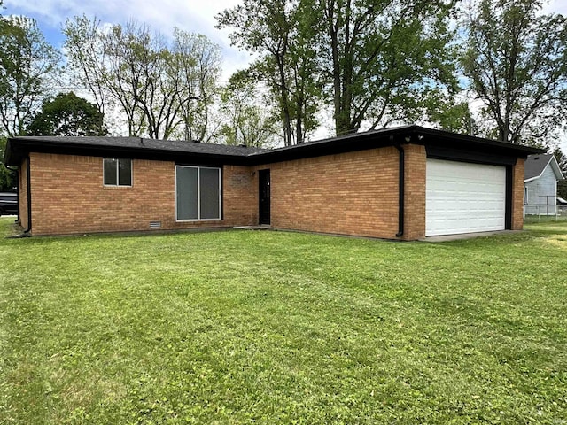 100 Lincoln St, Plainfield, IN 46168 - rear view of house with brick siding, a yard, and an attached garage