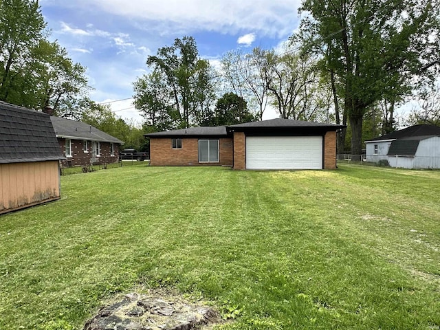 100 Lincoln St, Plainfield, IN 46168 - rear view of house featuring brick siding, an attached garage, a storage unit, and driveway