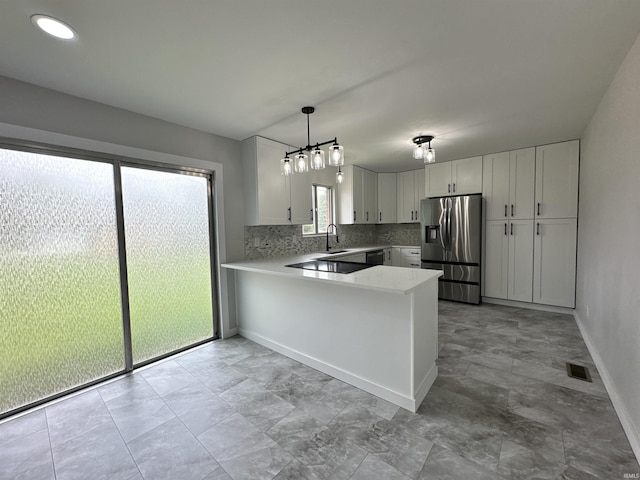 100 Lincoln St, Plainfield, IN 46168 - kitchen featuring stainless steel fridge with ice dispenser, light countertops, a peninsula, white cabinetry, and recessed lighting
