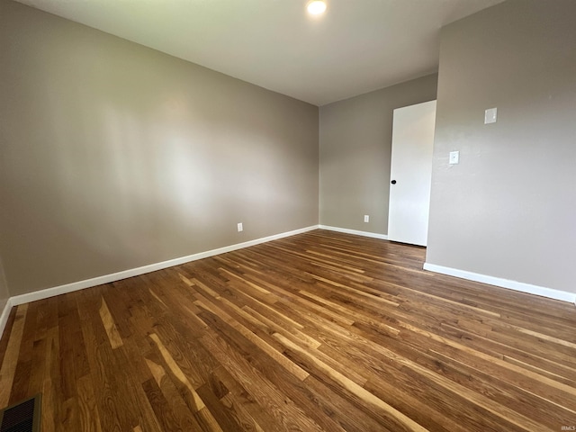 100 Lincoln St, Plainfield, IN 46168 - spare room featuring dark wood-style flooring and baseboards