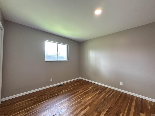 100 Lincoln St, Plainfield, IN 46168 - empty room with baseboards and dark wood-type flooring