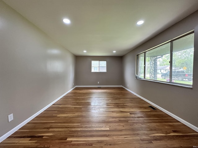 100 Lincoln St, Plainfield, IN 46168 - spare room with dark wood-style floors, recessed lighting, and baseboards