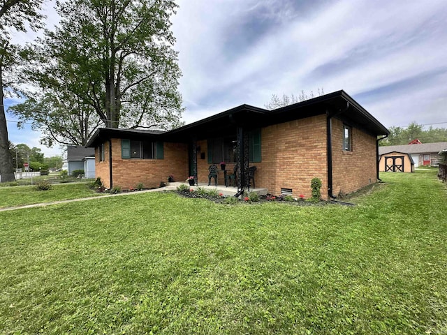 100 Lincoln St, Plainfield, IN 46168 - ranch-style home featuring a storage unit, brick siding, a front yard, and an outbuilding