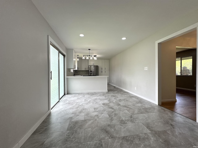 100 Lincoln St, Plainfield, IN 46168 - unfurnished living room featuring baseboards, recessed lighting, and a chandelier