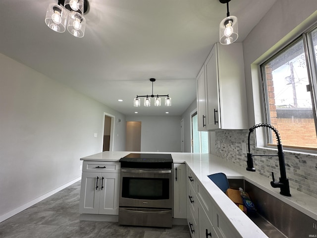 100 Lincoln St, Plainfield, IN 46168 - kitchen featuring stainless steel electric stove, a sink, tasteful backsplash, a peninsula, and light stone counters