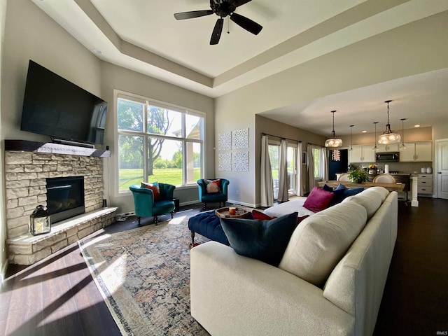7828 E Cherokee Rd, Syracuse, IN 46567 - living area with a ceiling fan, a fireplace, a high ceiling, and baseboards