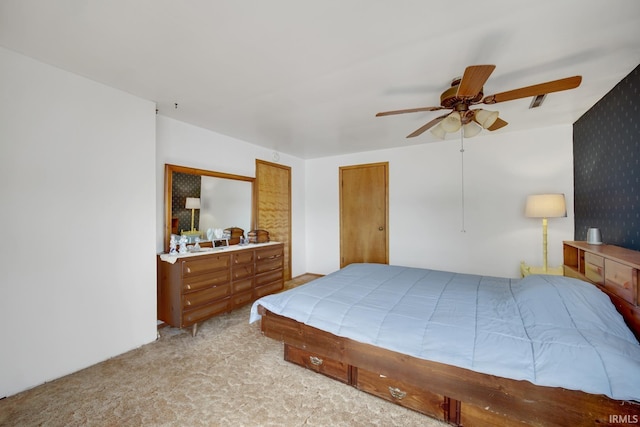 bedroom featuring light colored carpet and ceiling fan