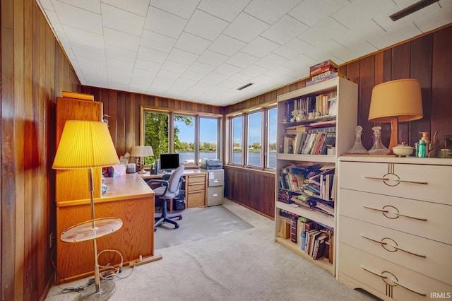 office area with wooden walls and light colored carpet