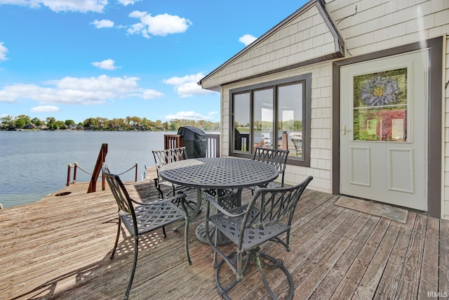 wooden terrace featuring a water view