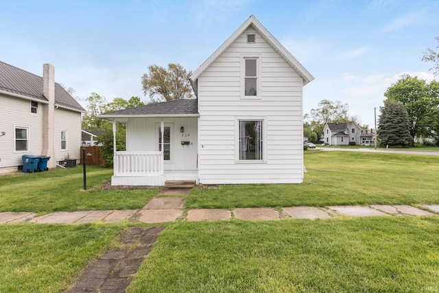 308 N Baltimore St, Bremen, IN 46506 - view of front of property with a porch, a front yard, and a shingled roof