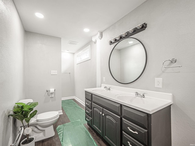 630 E Water St, Mount Vernon, IN 47620 - full bathroom with wood finished floors, toilet, double vanity, baseboards, and recessed lighting