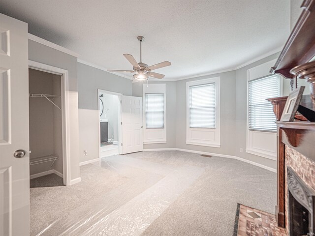 630 E Water St, Mount Vernon, IN 47620 - unfurnished living room with carpet floors, ceiling fan, ornamental molding, a fireplace, and baseboards