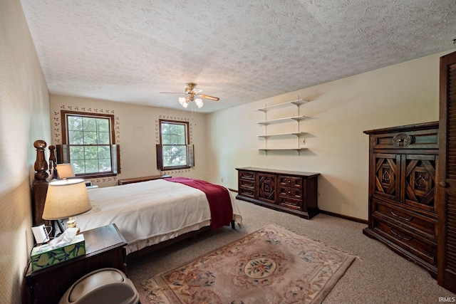 bedroom with carpet flooring, a textured ceiling, ceiling fan, and baseboards