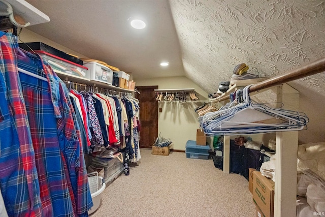 spacious closet featuring lofted ceiling and carpet flooring