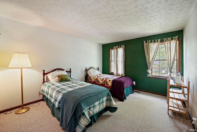 carpeted bedroom with baseboards and a textured ceiling