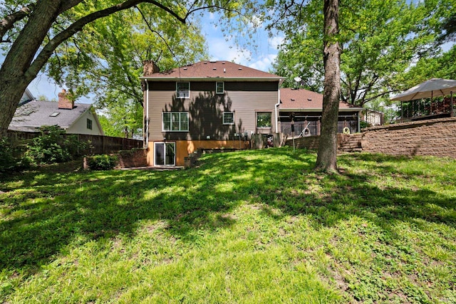 back of property featuring a chimney, stairs, and a deck