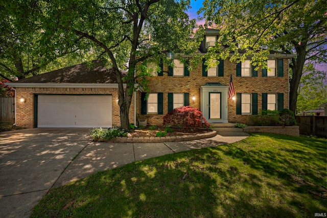 view of front of home featuring concrete driveway, brick siding, and a garage
