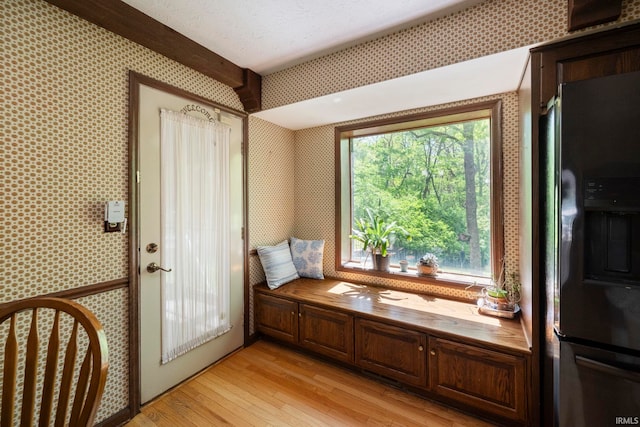 living area featuring light wood-style floors and wallpapered walls