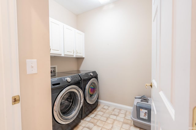 laundry room with cabinet space, washer and clothes dryer, and baseboards