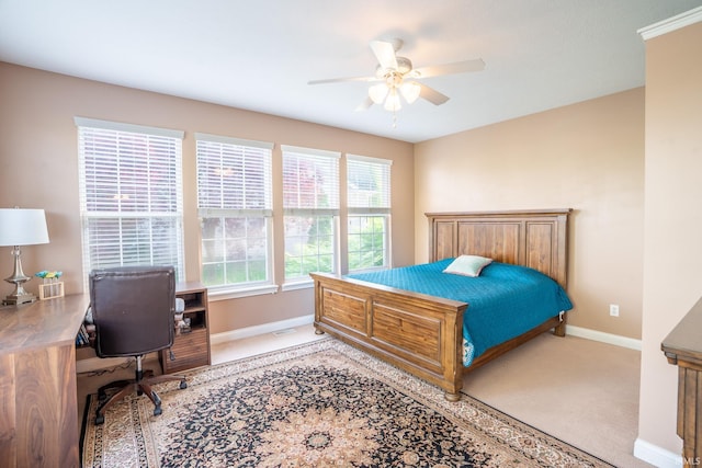 carpeted bedroom featuring baseboards, an office area, and ceiling fan