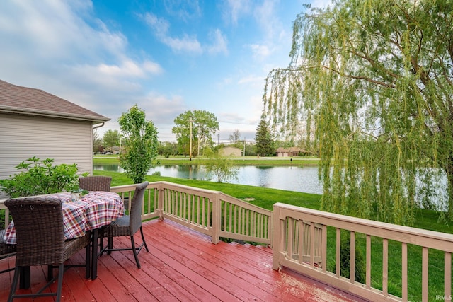 wooden terrace featuring a water view and a yard