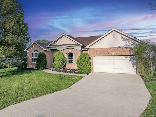 ranch-style house with brick siding, a garage, a front lawn, and driveway