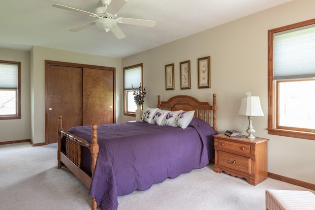 bedroom with carpet flooring, a closet, baseboards, and ceiling fan