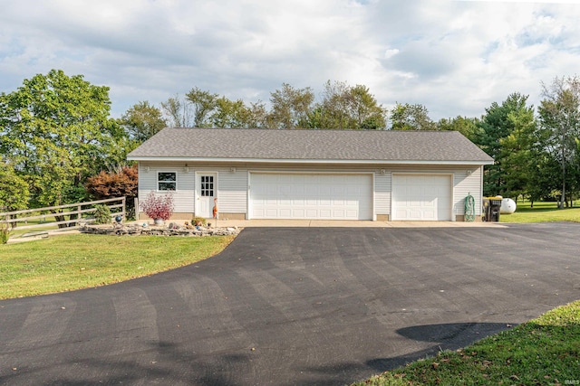 view of front of home with a garage and an outdoor structure